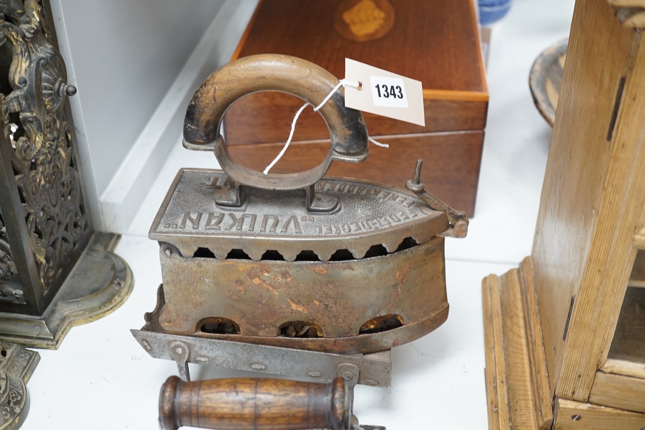 Four French coal/slug irons, three trivets and a stripped pine glazed cabinet, 37cm high